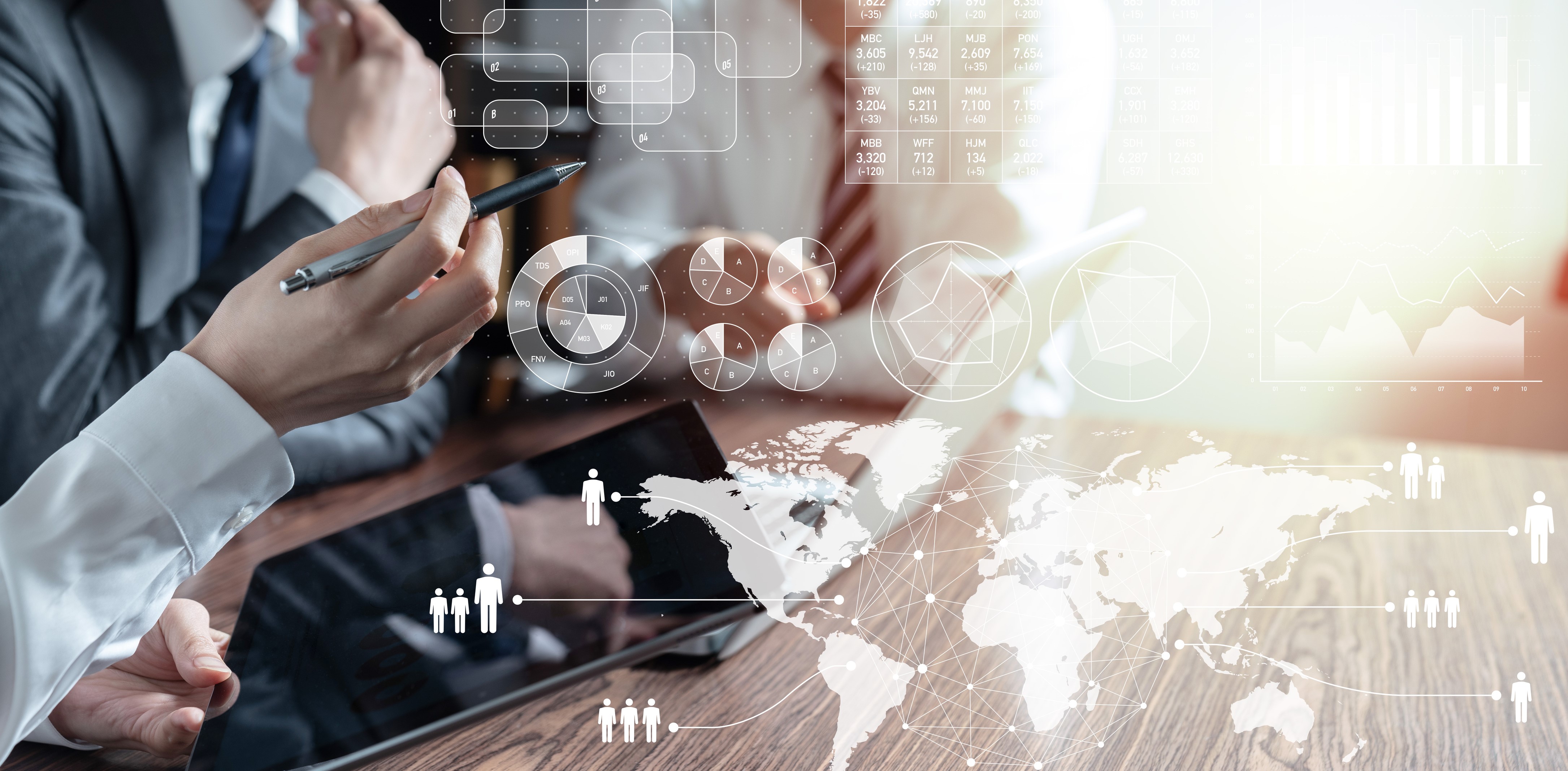 Two Mean and a Woman Strategizing With Laptop and Tablet at a Table
